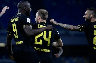 (From L) Inter Milan's Belgian forward Romelu Lukaku, Inter Milan's Danish midfielder Christian Eriksen and Inter Milan's Croatian defender Marcelo Brozovic celebrate after Eriksen opened the scoring during the Italian Cup (Coppa Italia) semi-final second leg football match Napoli vs Inter Milan on June 13, 2020 at the San Paolo stadium in Naples, played behind closed doors as the country gradually eases its lockdown aimed at curbing the spread of the COVID-19 infection, caused by the novel coronavirus. (Photo by Filippo MONTEFORTE / AFP) (Photo by FILIPPO MONTEFORTE/AFP via Getty Images)