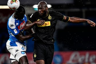 Napoli's Senegalese defender Kalidou Koulibaly (L) and Inter Milan's Belgian forward Romelu Lukaku go for a header during the Italian Cup (Coppa Italia) semi-final second leg football match Napoli vs Inter Milan on June 13, 2020 at the San Paolo stadium in Naples, played behind closed doors as the country gradually eases its lockdown aimed at curbing the spread of the COVID-19 infection, caused by the novel coronavirus. (Photo by Filippo MONTEFORTE / AFP) (Photo by FILIPPO MONTEFORTE/AFP via Getty Images)