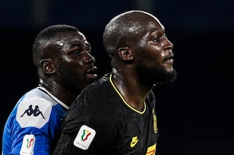 Napoli's Senegalese defender Kalidou Koulibaly (L) holds off Inter Milan's Belgian forward Romelu Lukaku during the Italian Cup (Coppa Italia) semi-final second leg football match Napoli vs Inter Milan on June 13, 2020 at the San Paolo stadium in Naples, played behind closed doors as the country gradually eases its lockdown aimed at curbing the spread of the COVID-19 infection, caused by the novel coronavirus. (Photo by Filippo MONTEFORTE / AFP) (Photo by FILIPPO MONTEFORTE/AFP via Getty Images)