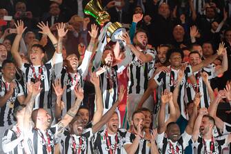 Juventus' players celebrate with the trophy at the end of the Italian Tim Cup (Coppa Italia) final Juventus vs AC Milan at the Olympic stadium on May 9, 2018 in Rome. - Juventus crushed AC Milan 4-0 on today at the Stadio Olimpico to win a fourth consecutive Italian Cup. Mehdi Benatia opened the floodgates after 56 minutes for the first of a double of the night for the Moroccan with Douglas Costa also finding the net in the space of nine minutes. A Nikola Kalinic own goal accounted for the fourth (Photo by Tiziana FABI / AFP)        (Photo credit should read TIZIANA FABI/AFP via Getty Images)