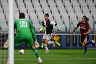 Juventus' Portuguese forward Cristiano Ronaldo (C) outruns AC Milan's Uruguayan midfielder Diego Laxalt during the Italian Cup (Coppa Italia) semi-final second leg football match Juventus vs AC Milan on June 12, 2020 at the Allianz stadium in Turin, the first to be played in Italy since March 9 and the lockdown aimed at curbing the spread of the COVID-19 infection, caused by the novel coronavirus. (Photo by Miguel MEDINA / AFP) (Photo by MIGUEL MEDINA/AFP via Getty Images)