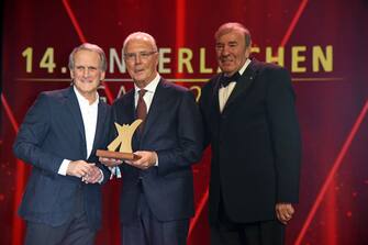 DORTMUND, GERMANY - DECEMBER 01: Wolfgang Overath, Franz Beckenbauer and Frank Flaschenberg during the 14th Kinderlachen Gala at Westfalenhalle on December 1, 2018 in Dortmund, Germany. (Photo by Tristar Media/Getty Images)