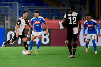 Juventus' Portuguese forward Cristiano Ronaldo (L) challenges Napoli's Italian defender Giovanni Di Lorenzo (2ndL) during the TIM Italian Cup (Coppa Italia) final football match Napoli vs Juventus on June 17, 2020 at the Olympic stadium in Rome, played behind closed doors as the country gradually eases the lockdown aimed at curbing the spread of the COVID-19 infection, caused by the novel coronavirus. (Photo by Filippo MONTEFORTE / AFP) (Photo by FILIPPO MONTEFORTE/AFP via Getty Images)