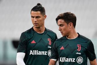 (From L) Juventus' Portuguese forward Cristiano Ronaldo (L) and Juventus' Argentine forward Paulo Dybala warm up prior to the Italian Cup (Coppa Italia) semi-final second leg football match Juventus vs AC Milan on June 12, 2020 at the Allianz stadium in Turin, the first to be played in Italy since March 9 and the lockdown aimed at curbing the spread of the COVID-19 infection, caused by the novel coronavirus. (Photo by Miguel MEDINA / AFP) (Photo by MIGUEL MEDINA/AFP via Getty Images)