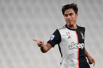 Juventus' Argentine forward Paulo Dybala celebrates after opening the scoring during the Italian Serie A football match Juventus vs Lecce played on June 26, 2020 behind closed doors at the Juventus stadium in Turin, as the country eases its lockdown aimed at curbing the spread of the COVID-19 infection, caused by the novel coronavirus. (Photo by Miguel MEDINA / AFP) (Photo by MIGUEL MEDINA/AFP via Getty Images)