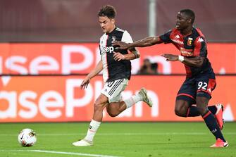 Juventus' Argentine forward Paulo Dybala (L) outruns Genoa's Malian French defender Adama Soumaoro during the Italian Serie A football match Genoa vs Juventus played on June 30, 2020 behind closed doors at the Luigi-Ferraris stadium in Genoa, as the country eases its lockdown aimed at curbing the spread of the COVID-19 infection, caused by the novel coronavirus. (Photo by Miguel MEDINA / AFP) (Photo by MIGUEL MEDINA/AFP via Getty Images)