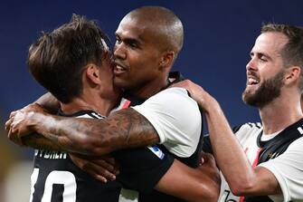 Juventus' Brazilian forward Douglas Costa (C) celebrates after scoring during the Italian Serie A football match Genoa vs Juventus played on June 30, 2020 behind closed doors at the Luigi-Ferraris stadium in Genoa, as the country eases its lockdown aimed at curbing the spread of the COVID-19 infection, caused by the novel coronavirus. (Photo by Miguel MEDINA / AFP) (Photo by MIGUEL MEDINA/AFP via Getty Images)