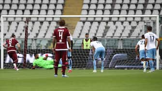 Torino's Italian forward Andrea Belotti (L) scores a penalty to open the scoring during the Italian Serie A football match Torino vs Lazio played on June 30, 2020 behind closed doors at the Olympic stadium in Turin, as the country eases its lockdown aimed at curbing the spread of the COVID-19 infection, caused by the novel coronavirus. (Photo by Isabella BONOTTO / AFP) (Photo by ISABELLA BONOTTO/AFP via Getty Images)