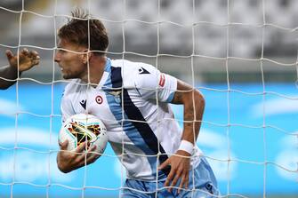 Lazio's Italian forward Ciro Immobile grabs the ball after scoring an equalizer during the Italian Serie A football match Torino vs Lazio played on June 30, 2020 behind closed doors at the Olympic stadium in Turin, as the country eases its lockdown aimed at curbing the spread of the COVID-19 infection, caused by the novel coronavirus. (Photo by Isabella BONOTTO / AFP) (Photo by ISABELLA BONOTTO/AFP via Getty Images)