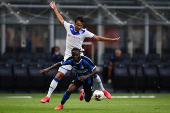 Brescia's Czech midfielder Ales Mateju (Rear) fouls Inter Milan's Nigerian defender Victor Moses in the penalty area during the Italian Serie A football match Inter vs Brescia played behind closed doors on July 1, 2020 at the Giuseppe-Meazza San Siro stadium in Milan, as the country eases its lockdown aimed at curbing the spread of the COVID-19 infection, caused by the novel coronavirus. (Photo by Miguel MEDINA / AFP) (Photo by MIGUEL MEDINA/AFP via Getty Images)