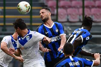 Inter Milan's Italian defender Danilo D'Ambrosio (C) scores a header during the Italian Serie A football match Inter vs Brescia played behind closed doors on July 1, 2020 at the Giuseppe-Meazza San Siro stadium in Milan, as the country eases its lockdown aimed at curbing the spread of the COVID-19 infection, caused by the novel coronavirus. (Photo by Miguel MEDINA / AFP) (Photo by MIGUEL MEDINA/AFP via Getty Images)