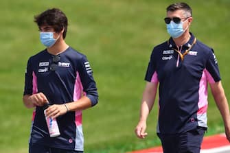 Williams' Canadian driver Nicholas Latifi (L) inspects the track with a member of his team on July 2, 2020, on the eve of the first practice session at the Austrian Formula One Grand Prix in Spielberg, Austria. - Seven months after they last competed in earnest, the Formula One circus will push a post-lockdown re-set button to open the 2020 season in Austria on July 5. (Photo by JOE KLAMAR / AFP) (Photo by JOE KLAMAR/AFP via Getty Images)