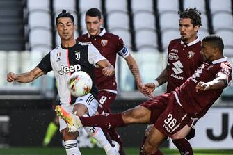 1224652137 Juventus' Portuguese forward Cristiano Ronaldo (L) and Torino's Brazilian defender Bremer (R) go for the ball during the Italian Serie A football match Juventus vs Torino played behind closed doors on July 4, 2020 at the Juventus stadium in Turin, as the country eases its lockdown aimed at curbing the spread of the COVID-19 infection, caused by the novel coronavirus. (Photo by Marco BERTORELLO / AFP) (Photo by MARCO BERTORELLO/AFP via Getty Images)