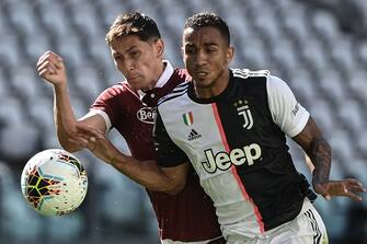 1224652219 Torino's Serbian midfielder Sasa Lukic (L) and Juventus' Brazilian defender Danilo go for the ball during the Italian Serie A football match Juventus vs Torino played behind closed doors on July 4, 2020 at the Juventus stadium in Turin, as the country eases its lockdown aimed at curbing the spread of the COVID-19 infection, caused by the novel coronavirus. (Photo by Marco BERTORELLO / AFP) (Photo by MARCO BERTORELLO/AFP via Getty Images)