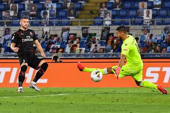 AC Milan's Croatian forward Ante Rebic (L) shoots to score the third goal past Lazio's Albanian goalkeeper Thomas Strakosha during the Italian Serie A football match Lazio vs AC Milan played behind closed doors on July 4, 2020 at the Olympic stadium in Rome, as the country eases its lockdown aimed at curbing the spread of the COVID-19 infection, caused by the novel coronavirus. (Photo by Tiziana FABI / AFP) (Photo by TIZIANA FABI/AFP via Getty Images)