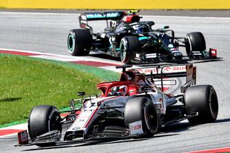Alfa Romeo's Finnish driver Kimi Raikkonen steers his car in front of Mercedes' Finnish driver Valtteri Bottas during the Austrian Formula One Grand Prix race on July 5, 2020 in Spielberg, Austria. (Photo by JOE KLAMAR / POOL / AFP) (Photo by JOE KLAMAR/POOL/AFP via Getty Images)