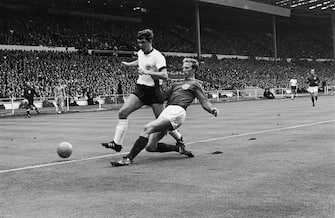 Jack Charlton tackles Wolfgang Weber for the ball during the 1966 World Cup final at Wembley Stadium, London, 30th July 1966. (Photo by Central Press/Hulton Archive/Getty Images)