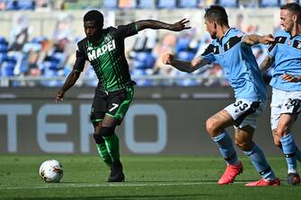 Sassuolo's Ivorian forward Jeremie Boga (L) challenges Lazio's Italian defender Francesco Acerbi and Lazio's Italian midfielder Manuel Lazzari (R) during the Italian Serie A football match Lazio Rome vs Sassuolo played behind closed doors on July 11, 2020 at the Olympic stadium in Rome, as the country eases its lockdown aimed at curbing the spread of the COVID-19 infection, caused by the novel coronavirus. (Photo by Vincenzo PINTO / AFP) (Photo by VINCENZO PINTO/AFP via Getty Images)
