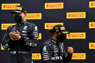 SPIELBERG, AUSTRIA - JULY 12: Race winner Lewis Hamilton of Great Britain and Mercedes GP and second placed Valtteri Bottas of Finland and Mercedes GP celebrate on the podium after the Formula One Grand Prix of Styria at Red Bull Ring on July 12, 2020 in Spielberg, Austria. (Photo by Joe Klamar/Pool via Getty Images)