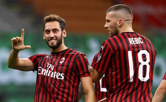 MILAN, ITALY - JULY 18:  Hakan Calhanoglu of AC Milan celebrates after scoring the second goal of his team during the Serie A match between AC Milan and Bologna FC at Stadio Giuseppe Meazza on July 18, 2020 in Milan, Italy.  (Photo by Marco Luzzani/Getty Images)