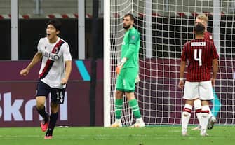 MILAN, ITALY - JULY 18:  Takehiro Tomiyasu (L) of Bologna FC celebrates his goal during the Serie A match between AC Milan and Bologna FC at Stadio Giuseppe Meazza on July 18, 2020 in Milan, Italy.  (Photo by Marco Luzzani/Getty Images)