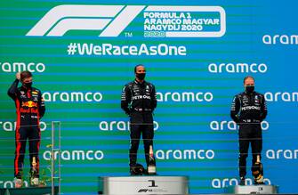 (L to R) Second placed Red Bull's Dutch driver Max Verstappen, winner Mercedes' British driver Lewis Hamilton and third placed Mercedes' Finnish driver Valtteri Bottas stand on the podium of the Formula One Hungarian Grand Prix race at the Hungaroring circuit in Mogyorod near Budapest, Hungary, on July 19, 2020. (Photo by Leonhard Foeger / POOL / AFP) (Photo by LEONHARD FOEGER/POOL/AFP via Getty Images)