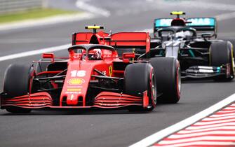BUDAPEST, HUNGARY - JULY 19: Charles Leclerc of Monaco driving the (16) Scuderia Ferrari SF1000 leads Valtteri Bottas of Finland driving the (77) Mercedes AMG Petronas F1 Team Mercedes W11 during the Formula One Grand Prix of Hungary at Hungaroring on July 19, 2020 in Budapest, Hungary. (Photo by Mark Thompson/Getty Images)