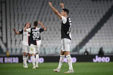 Juventus' Portuguese forward Cristiano Ronaldo (R) celebrates at the end of the Italian Serie A football match between Juventus and Lazio, on July 20, 2020 at the Allianz stadium, in Turin, northern Italy. (Photo by Marco BERTORELLO / AFP) (Photo by MARCO BERTORELLO/AFP via Getty Images)