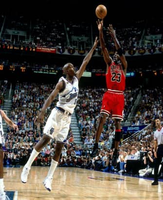 SALT LAKE CITY - JUNE 14:  Michael Jordan #23 of the Chicago Bulls shoots a jump shot against Bryon Russell #3 the Utah Jazz in Game Six of the 1998 NBA Finals against the Chicago Bulls at the Delta Center on June 14, 1998 in Salt Lake City, Utah.  The Bulls defeated the Jazz 87-86.  NOTE TO USER: User expressly acknowledges that, by downloading and or using this photograph, User is consenting to the terms and conditions of the Getty Images License agreement. Mandatory Copyright Notice: Copyright 1998 NBAE (Photo by Nathaniel S. Butler/NBAE via Getty Images)