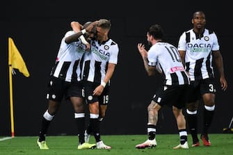 Udinese's Ivorian midfielder Seko Fofana (L)  celebrates with   teammates  after scoring a goal during  Italian Serie A football match between Udinese and Juventus on July 23, 2020, at the Dacia Arena Stadium in Udine. (Photo by MARCO BERTORELLO / AFP) (Photo by MARCO BERTORELLO/AFP via Getty Images)