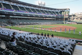 epa08565099 A member of the Chicago White Sox organization (L) kneels along with some of the players during the National Anthem before the start of the MLB baseball game between the Minnesota Twins and the Chicago White Sox at Guaranteed Rate Field in Chicago, Illinois, USA, 24 July 2020. Major League Baseball has started an abbreviated 2020 season playing in ballparks without fans.  EPA/TANNEN MAURY