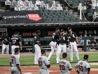 epa08565102 Players are introduced before cutout images of fans in the stands before the start of the MLB baseball game between the Minnesota Twins and the Chicago White Sox at Guaranteed Rate Field in Chicago, Illinois, USA, 24 July 2020. Major League Baseball has started an abbreviated 2020 season playing in ballparks without fans.  EPA/TANNEN MAURY