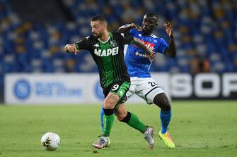 NAPLES, ITALY - JULY 25: Francesco Caputo of US Sassuolo vies with Kalidou Koulibaly of SSC Napoli during the Serie A match between SSC Napoli and  US Sassuolo at Stadio San Paolo on July 25, 2020 in Naples, Italy. (Photo by Francesco Pecoraro/Getty Images)