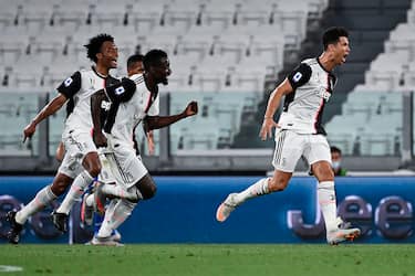 Juventus' Portuguese forward Cristiano Ronaldo (R) celebrates after scoring during the Italian Serie A football match between Juventus and Sampdoria played behind closed doors at the Allianz Stadium in Turin on July 26, 2020. (Photo by MARCO BERTORELLO / AFP) (Photo by MARCO BERTORELLO/AFP via Getty Images)
