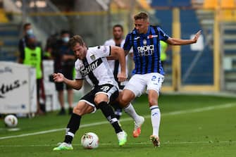 Parma's Italian defender Riccardo Gagliolo (L) fights for the ball with Atalanta's Belgian defender Timothy Castagne during the Italian Serie A football match Parma vs Atalanta played behind closed doors at the Ennio-Tardini stadium in Parma, on July 28, 2020 as the country eases its lockdown aimed at curbing the spread of the COVID-19 infection, caused by the novel coronavirus. (Photo by MIGUEL MEDINA / AFP) (Photo by MIGUEL MEDINA/AFP via Getty Images)