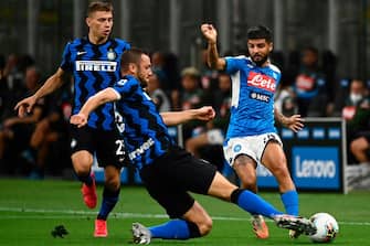 Inter Milan's Dutch defender Stefan de Vrij (L) vies with Napoli's Italian forward Lorenzo Insigne during the Italian Serie A football match Inter Milan vs Napoli played behind closed doors at the San Siro Stadium in Milan, on July 28, 2020. (Photo by MARCO BERTORELLO / AFP) (Photo by MARCO BERTORELLO/AFP via Getty Images)