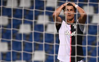 1227429871 Juventus' Portuguese forward Cristiano Ronaldo reacts after missing a goal opportunity during the Italian Serie A football match between Sassuolo and Juventus Turin played behind closed doors on July 15, 2020 at the Mapei stadium in Reggio Emilia. (Photo by MARCO BERTORELLO / AFP) (Photo by MARCO BERTORELLO/AFP via Getty Images)