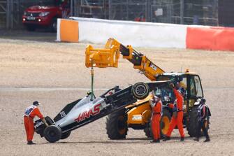 The Haas F1 car of Danish driver Kevin Magnussen is taken away after a crash during the Formula One British Grand Prix at the Silverstone motor racing circuit in Silverstone, central England on August 2, 2020. (Photo by Bryn Lennon / POOL / AFP) (Photo by BRYN LENNON/POOL/AFP via Getty Images)