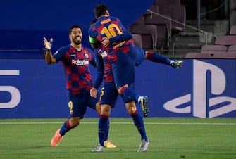 Barcelona's French defender Clement Lenglet (C) celebrates with Barcelona's Argentine forward Lionel Messi (R) and Barcelona's Uruguayan forward Luis Suarez (R) after scoring a goal during the UEFA Champions League round of 16 second leg football match between FC Barcelona and Napoli at the Camp Nou stadium in Barcelona on August 8, 2020. (Photo by LLUIS GENE / AFP) (Photo by LLUIS GENE/AFP via Getty Images)