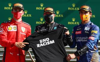 (L-R) Ferrari's Monegasque driver Charles Leclerc, Mercedes' Finnish driver Valtteri Bottas and McLaren's British driver Lando Norris pose with a "End Racism" t-shirt on the podium after the Austrian Formula One Grand Prix race on July 5, 2020 in Spielberg, Austria. (Photo by Mark Thompson / POOL / AFP) (Photo by MARK THOMPSON/POOL/AFP via Getty Images)