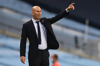 Real Madrid's French coach Zinedine Zidane shouts instructions to his players from the touchline during the UEFA Champions League round of 16 second leg football match between Manchester City and Real Madrid at the Etihad Stadium in Manchester, north west England on August 7, 2020. (Photo by Shaun Botterill / POOL / AFP) (Photo by SHAUN BOTTERILL/POOL/AFP via Getty Images)