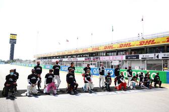 BARCELONA, SPAIN - AUGUST 16: The F1 drivers take a knee on the grid in support of the Black Lives Matter movement prior to the F1 Grand Prix of Spain at Circuit de Barcelona-Catalunya on August 16, 2020 in Barcelona, Spain. (Photo by Bryn Lennon/Getty Images)