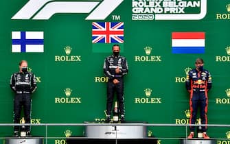 Winner Mercedes' British driver Lewis Hamilton (C) celebrates on the podium next to second placed Mercedes' Finnish driver Valtteri Bottas (L) and third placed Red Bull's Dutch driver Max Verstappen after the Belgian Formula One Grand Prix at the Spa-Francorchamps circuit in Spa on August 30, 2020. (Photo by JOHN THYS / POOL / AFP) (Photo by JOHN THYS/POOL/AFP via Getty Images)