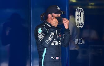 Mercedes' British driver Lewis Hamilton puts on his mask after winning the pole position in the qualifying session at the Autodromo Nazionale circuit in Monza on September 5, 2020 ahead of the Italian Formula One Grand Prix. (Photo by JENNIFER LORENZINI / POOL / AFP) (Photo by JENNIFER LORENZINI/POOL/AFP via Getty Images)