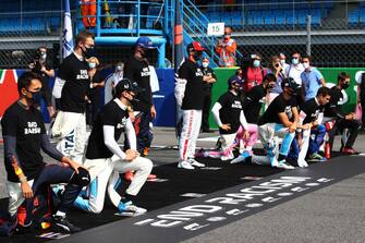 MONZA, ITALY - SEPTEMBER 06: The F1 drivers take a knee on the grid in support of the Black Lives Matter movement prior to the F1 Grand Prix of Italy at Autodromo di Monza on September 06, 2020 in Monza, Italy. (Photo by Mark Thompson/Getty Images)