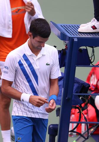 NEW YORK, NEW YORK - SEPTEMBER 06: Novak Djokovic of Serbia looks on after being defaulted due to inadvertently striking a lineswoman with a ball hit in frustration during his Men's Singles fourth round match against Pablo Carreno Busta of Spain on Day Seven of the 2020 US Open at the USTA Billie Jean King National Tennis Center on September 6, 2020 in the Queens borough of New York City.   Al Bello/Getty Images/AFP
== FOR NEWSPAPERS, INTERNET, TELCOS & TELEVISION USE ONLY ==