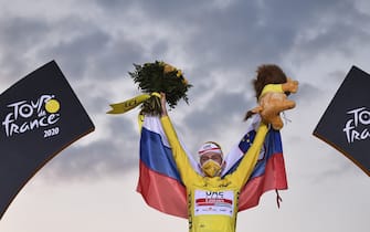 Team UAE Emirates rider Slovenia's Tadej Pogacar wearing the overall leader's yellow jersey celebrates on the podium after winning the 107th edition of the Tour de France cycling race, after the 21st and last stage of 122 km between Mantes-la-Jolie and Champs Elysees Paris, on September 20, 2020. (Photo by Anne-Christine POUJOULAT / AFP) (Photo by ANNE-CHRISTINE POUJOULAT/AFP via Getty Images)