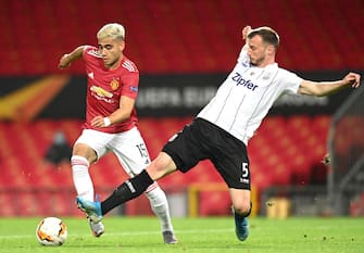 MANCHESTER, ENGLAND - AUGUST 05: Petar Filipovic of LASK tackles Andreas Pereira of Manchester United during the UEFA Europa League round of 16 second leg match between Manchester United and LASK at Old Trafford on August 05, 2020 in Manchester, England. (Photo by Michael Regan/Getty Images)