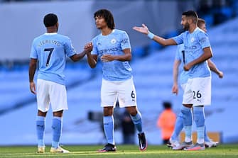 MANCHESTER, ENGLAND - SEPTEMBER 27: Nathan Ake of Manchester City shakes hands with teammate Raheem Sterling prior to the Premier League match between Manchester City and Leicester City at Etihad Stadium on September 27, 2020 in Manchester, England. Sporting stadiums around the UK remain under strict restrictions due to the Coronavirus Pandemic as Government social distancing laws prohibit fans inside venues resulting in games being played behind closed doors. (Photo by Laurence Griffiths/Getty Images)