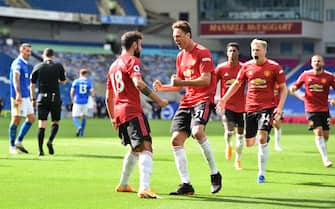 BRIGHTON, ENGLAND - SEPTEMBER 26: Bruno Fernandes of Manchester United celebrates with teammates after scoring his sides third goal during the Premier League match between Brighton & Hove Albion and Manchester United at American Express Community Stadium on September 26, 2020 in Brighton, England. Sporting stadiums around the UK remain under strict restrictions due to the Coronavirus Pandemic as Government social distancing laws prohibit fans inside venues resulting in games being played behind closed doors. (Photo by Glyn Kirk - Pool/Getty Images)